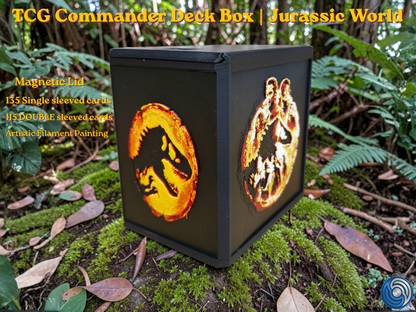 Jurassic World-themed TCG Commander deck box, UK-made 3D-printed EDH vault with HueForge artistic filament painting dinosaur design, magnetic lid, commander card display window with free premium toploader, holds 115 double-sleeved or 135 single-sleeved cards, compatible with MTG, One Piece TCG, Disney Lorcana, Flesh and Blood, Yu-Gi-Oh, Pokémon, photographed in jungle forest setting